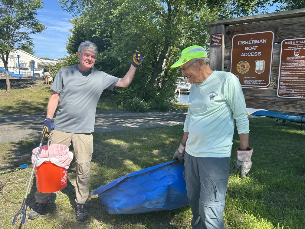 Volunteers brining kiddie pool up from river