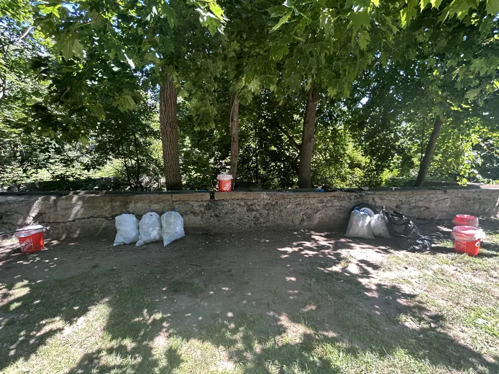 Bags of litter and buckets along foundations